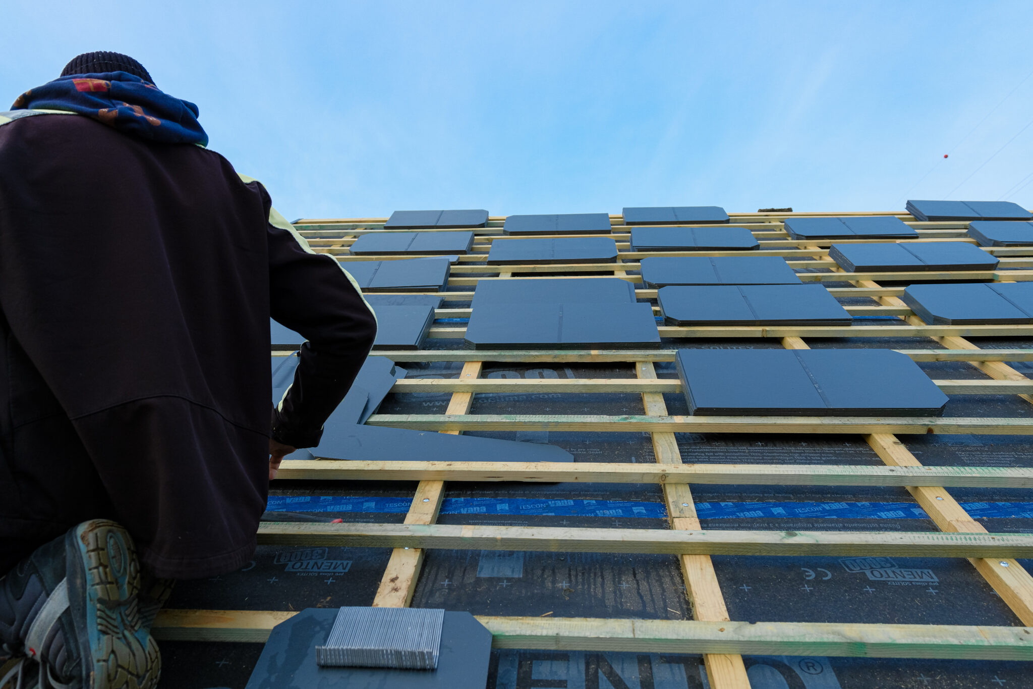 Chantier de sarking : pose de l'isolant et des liteaux sur une toiture par l'extérieur par ISOLUTION en Wallonie