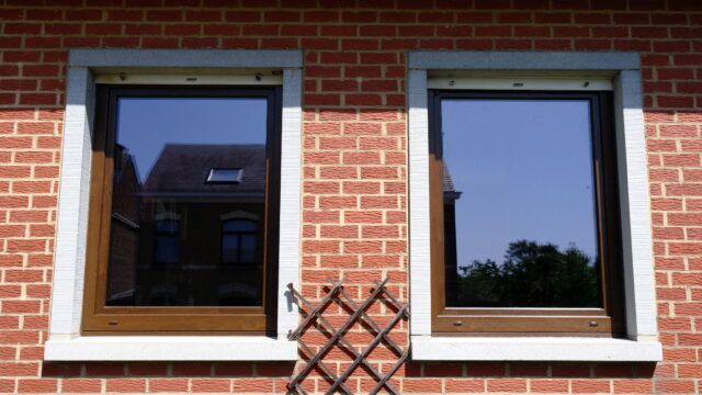 Deux châssis en bois posés par Isolution sur une façade en briques à Jambes, en Wallonie